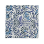 blue floral block-printed napkin laid flat on white background.


