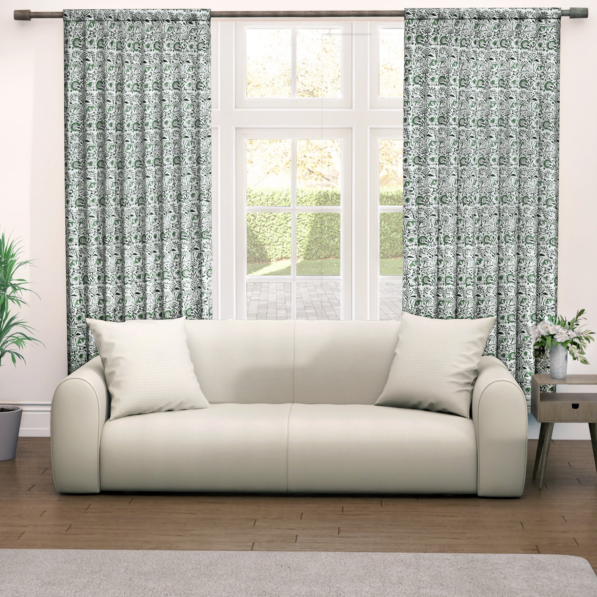 Semi-sheer cotton block print curtains in green, hanging in a room with a light filtering through, showcasing a boho-chic style.