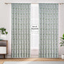 Semi-sheer cotton block print curtains in green, hanging in a room with a light filtering through, showcasing a boho-chic style.