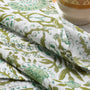 Close-up of detailed green and white floral print cotton napkin.