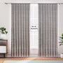 Semi-sheer cotton block print curtains in gray with intricate patterns, hanging in a room with a light source behind them, showcasing their transparent quality and rod pocket design.