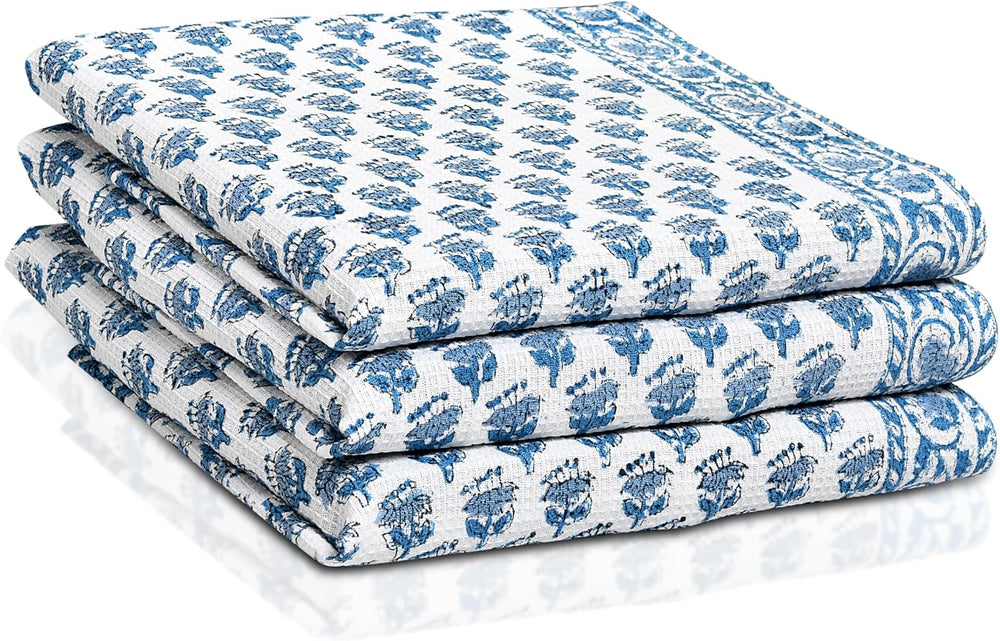Set of three folded Apatite Blue waffle cotton towels with floral hand block print

