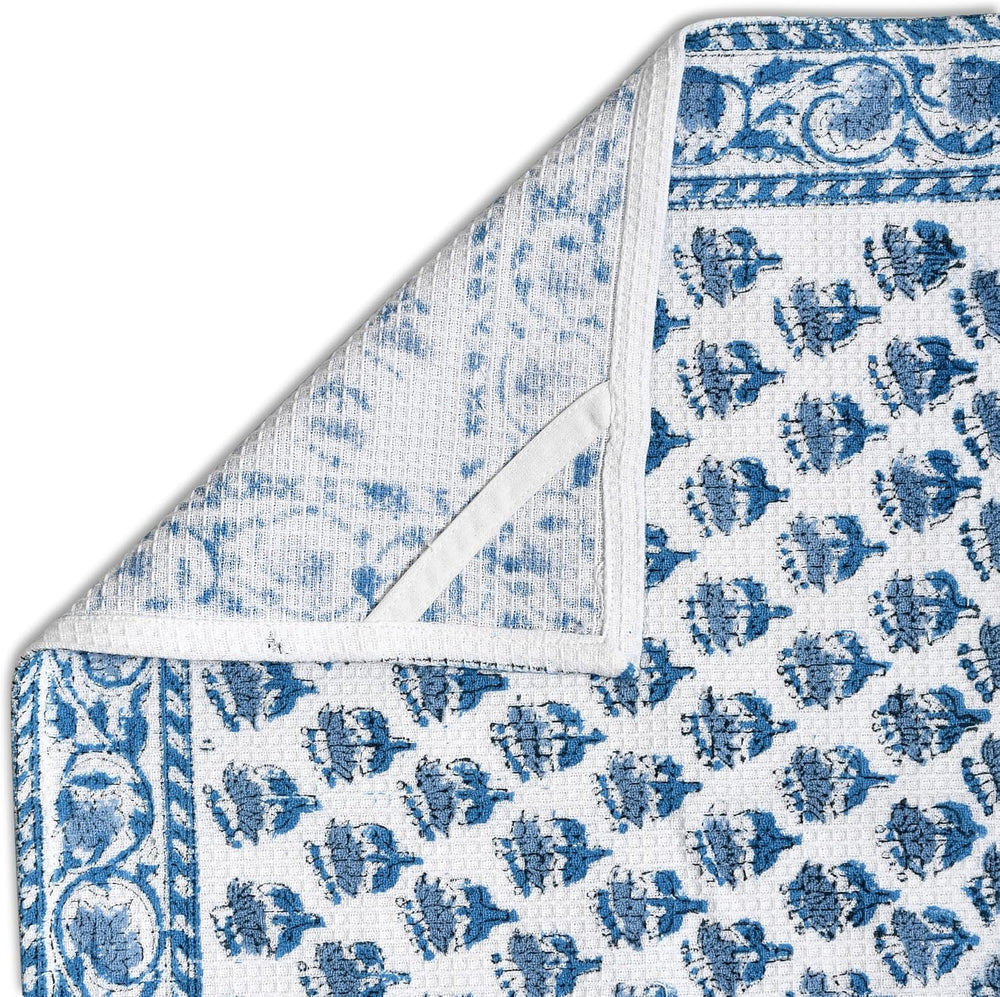 Corner fold view of towel showing floral design and waffle texture


