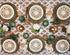 Dinner Table Setup with Plates, Placemats, Silverware, and Cotton Forest Green Tablecloth