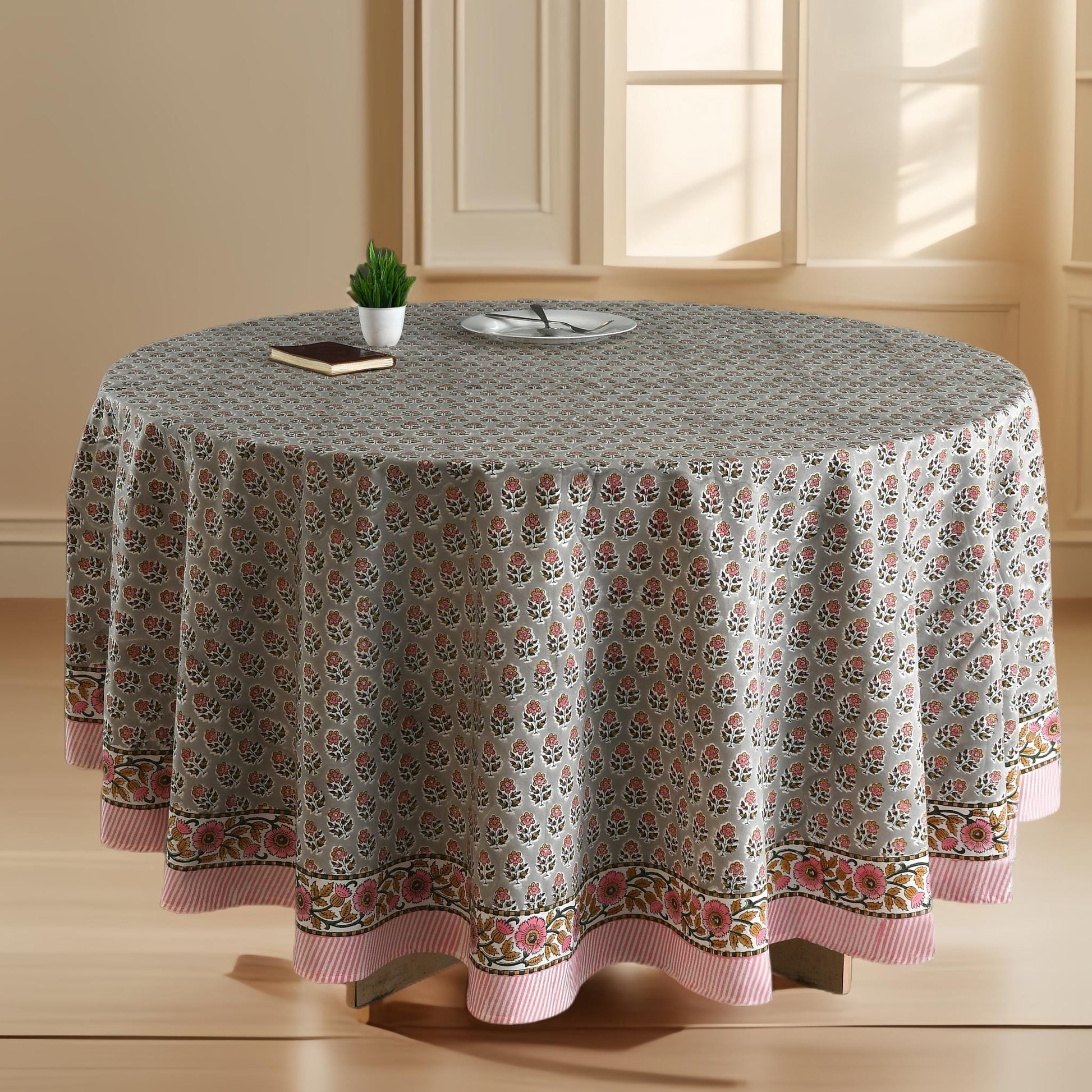 a round table with a flowered tablecloth on it