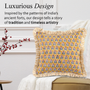 Pair of yellow and red floral block print pillows with ruffled trim arranged neatly on a cream couch.