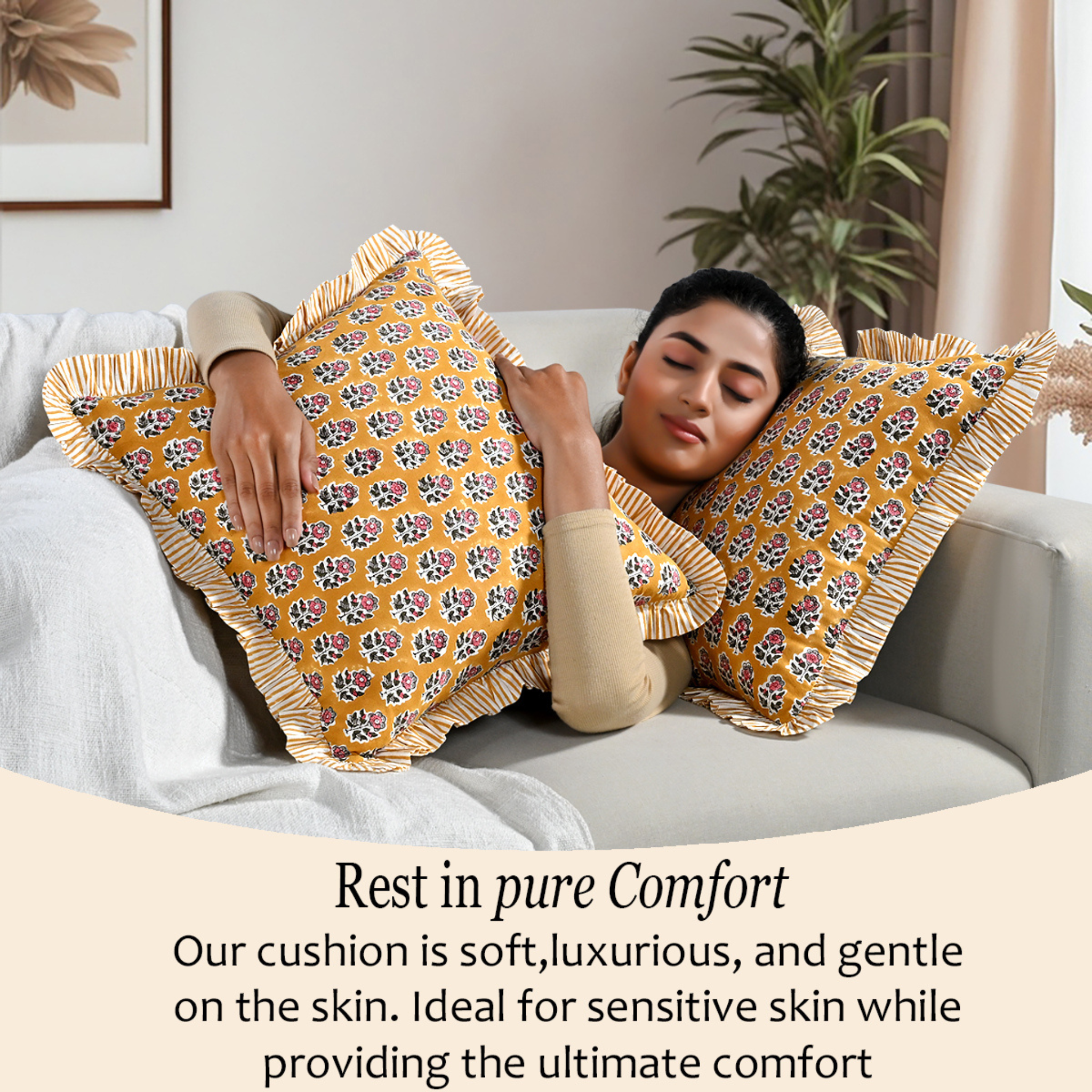 Woman relaxing on a couch with two bohemian floral pillows for comfort and cozy home décor